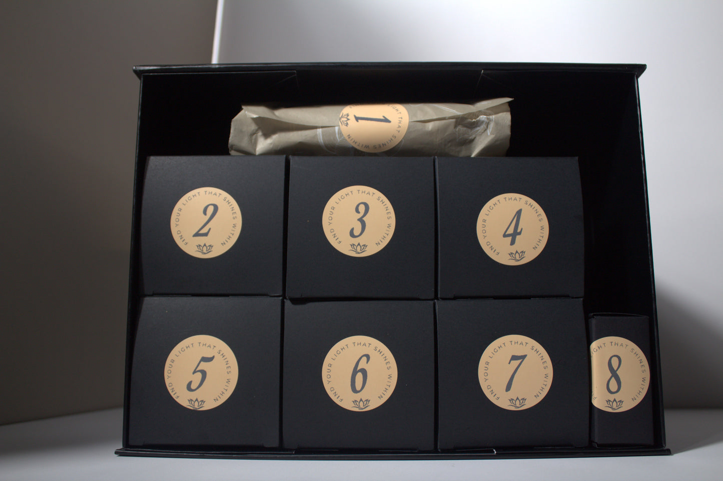 Wrapped Self-Care Advent Giftset in Black Boxes with orange stickers with black font for Liv 4 You 2.