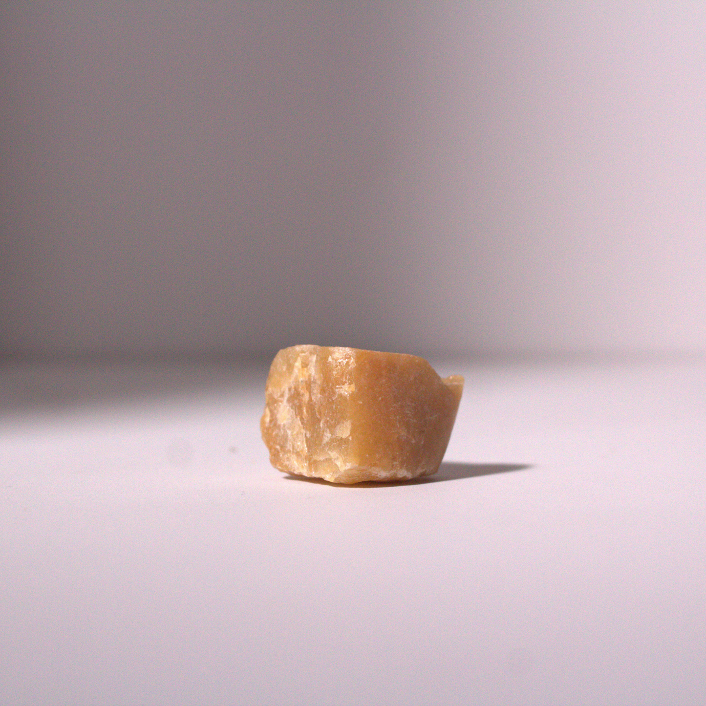 Raw Honey Onyx Stone on white table for Liv 4 You 2.
