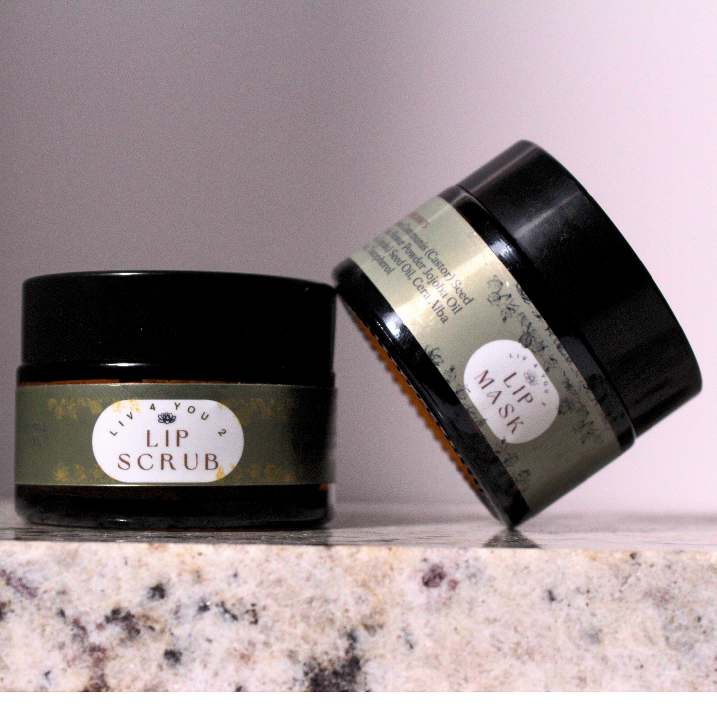 Lip scrub and lip mask set with green and white labels, brown font on granite foundation.