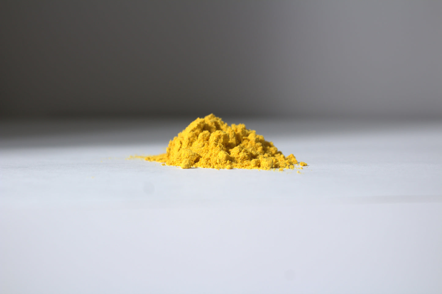 Yellow turmeric face mask powder on white surface with gray background Liv 4 You 2